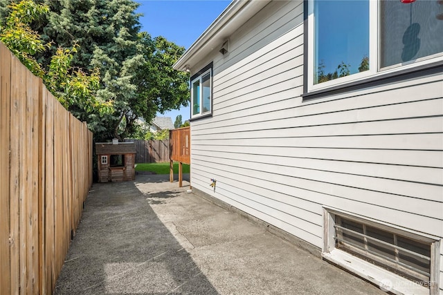 1210 S Mcclellan St, Seattle, WA 98144 - view of side of home with a fenced backyard and a patio