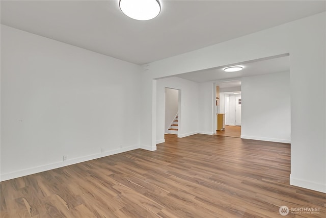 4117 S M St, Tacoma, WA 98418 - spare room with stairway, wood finished floors, and baseboards