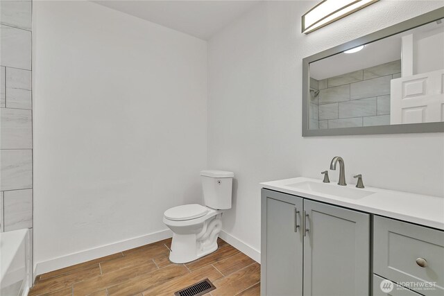 4117 S M St, Tacoma, WA 98418 - full bathroom featuring vanity, wood finish floors, toilet, and baseboards