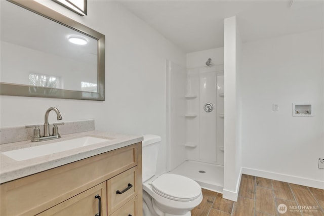 4117 S M St, Tacoma, WA 98418 - bathroom with toilet, wood tiled floors, vanity, a shower, and baseboards