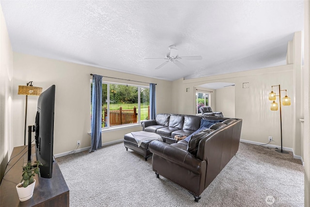 2957 Unick Rd, Ferndale, WA 98248 - living room featuring arched walkways, a ceiling fan, carpet floors, baseboards, and a textured ceiling