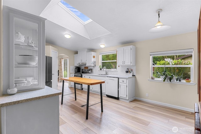 2957 Unick Rd, Ferndale, WA 98248 - kitchen with dishwasher, light countertops, a sink, arched walkways, and lofted ceiling