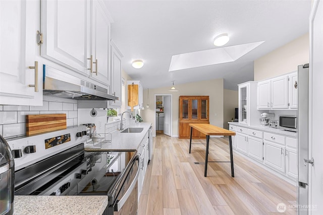 2957 Unick Rd, Ferndale, WA 98248 - kitchen featuring appliances with stainless steel finishes, a skylight, under cabinet range hood, a sink, and lofted ceiling