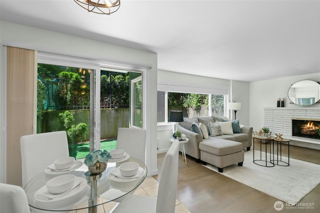 705 E Republican St Unit A, Seattle, WA 98102 - dining room with light wood-type flooring and a fireplace