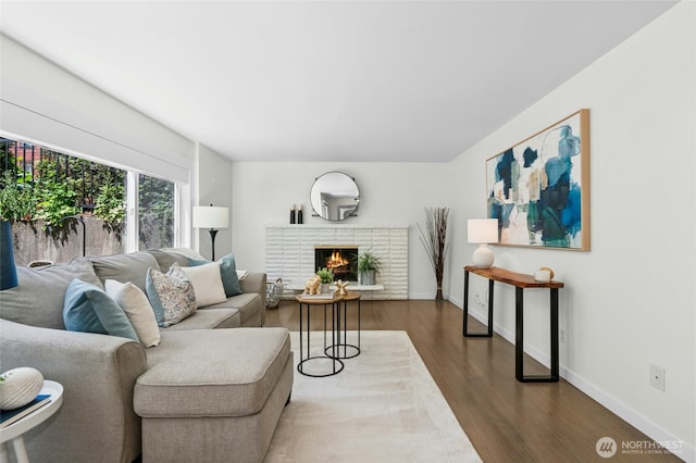 705 E Republican St Unit A, Seattle, WA 98102 - living area featuring wood finished floors, a fireplace, and baseboards