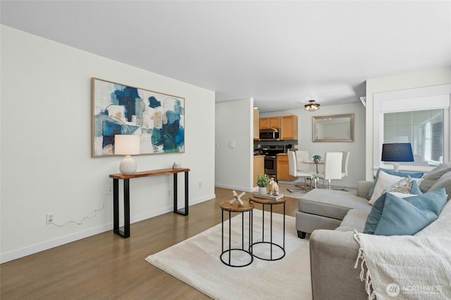 705 E Republican St Unit A, Seattle, WA 98102 - living room featuring wood finished floors and baseboards