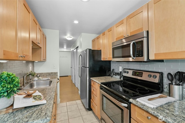 705 E Republican St Unit A, Seattle, WA 98102 - kitchen with stainless steel appliances, a sink, light brown cabinetry, backsplash, and light tile patterned floors