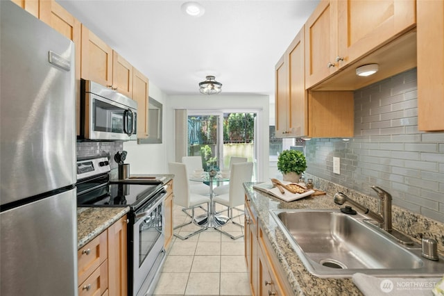705 E Republican St Unit A, Seattle, WA 98102 - kitchen featuring stainless steel appliances, light brown cabinets, a sink, tasteful backsplash, and light tile patterned floors