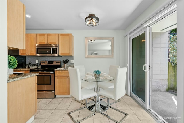 705 E Republican St Unit A, Seattle, WA 98102 - kitchen with stainless steel appliances, light brown cabinets, tasteful backsplash, and light tile patterned flooring