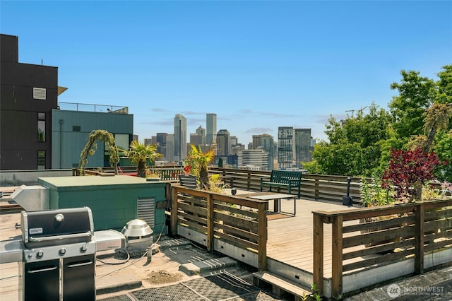 705 E Republican St Unit A, Seattle, WA 98102 - view of patio / terrace featuring a wooden deck, area for grilling, and a skyline view