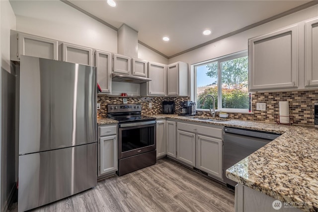 2438 Highland View Dr, East Wenatchee, WA 98802 - kitchen with stainless steel appliances, ornamental molding, light wood-type flooring, light stone counters, and tasteful backsplash