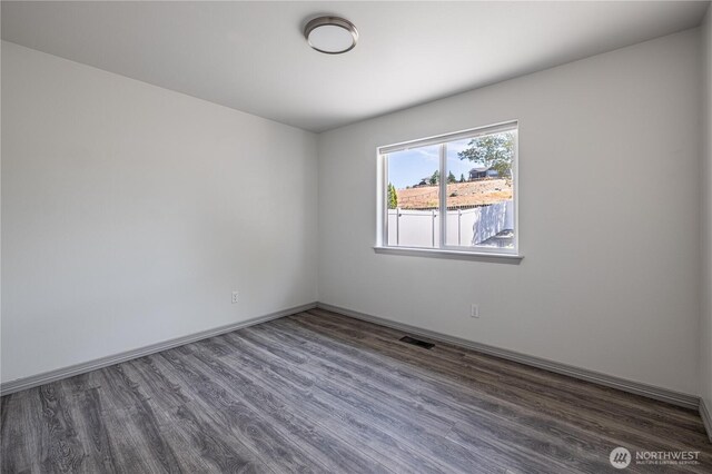 2438 Highland View Dr, East Wenatchee, WA 98802 - empty room with dark wood-type flooring and baseboards