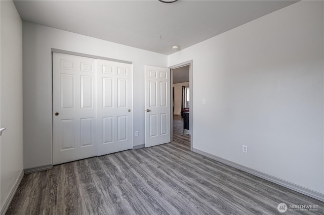 2438 Highland View Dr, East Wenatchee, WA 98802 - unfurnished bedroom featuring wood finished floors and a closet