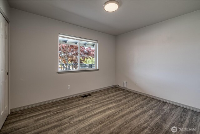 2438 Highland View Dr, East Wenatchee, WA 98802 - empty room featuring dark wood finished floors and baseboards