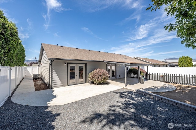 2438 Highland View Dr, East Wenatchee, WA 98802 - back of house featuring french doors, a patio, a shingled roof, and a fenced backyard