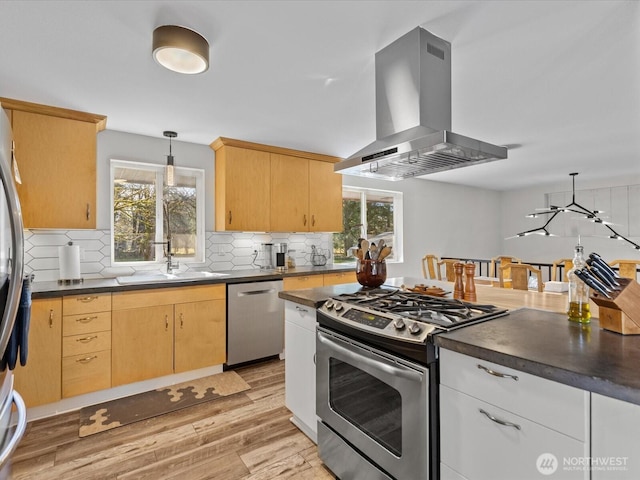 12020W Engebretsen Rd, Granite Falls, WA 98252 - kitchen with appliances with stainless steel finishes, island exhaust hood, dark countertops, and light wood-style floors