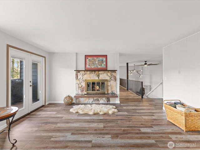 12020W Engebretsen Rd, Granite Falls, WA 98252 - living room featuring wood finished floors, a stone fireplace, and french doors