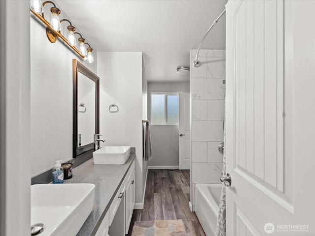 12020W Engebretsen Rd, Granite Falls, WA 98252 - full bath with double vanity, tub / shower combination, wood finished floors, and a textured ceiling