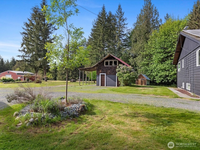 12020W Engebretsen Rd, Granite Falls, WA 98252 - view of grassy yard with a detached garage, driveway, an outdoor structure, and a barn