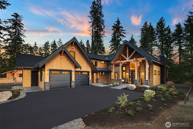 60 Portal Ct, Cle Elum, WA 98922 - view of front facade with an attached garage, asphalt driveway, and stone siding