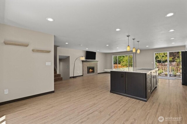 5208 S 380th St, Auburn, WA 98001 - kitchen featuring light wood-type flooring, a fireplace, recessed lighting, a kitchen island, and hanging light fixtures