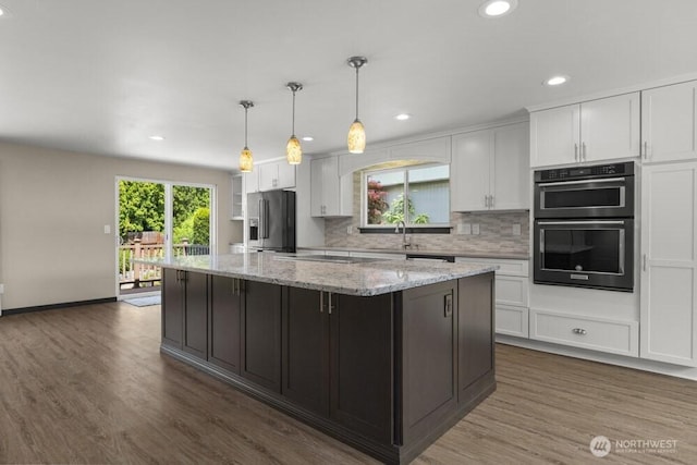 5208 S 380th St, Auburn, WA 98001 - kitchen with black appliances, white cabinetry, a kitchen island, dark wood finished floors, and recessed lighting