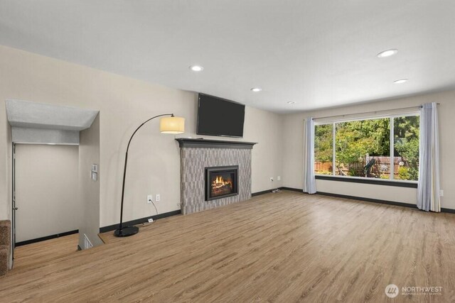 5208 S 380th St, Auburn, WA 98001 - unfurnished living room with wood finished floors, a glass covered fireplace, and recessed lighting