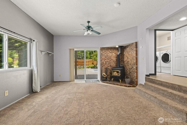 5208 S 380th St, Auburn, WA 98001 - unfurnished living room with independent washer and dryer, a wood stove, carpet flooring, ceiling fan, and a textured ceiling