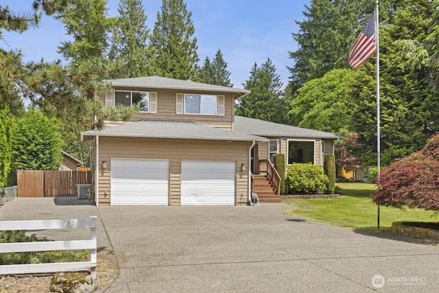 5208 S 380th St, Auburn, WA 98001 - tri-level home with asphalt driveway, a garage, and roof with shingles