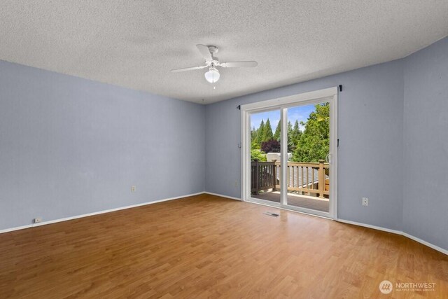 5208 S 380th St, Auburn, WA 98001 - unfurnished room with a ceiling fan, wood finished floors, and a textured ceiling