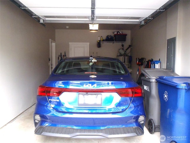 8727 E Gilman Ave, Arlington, WA 98223 - garage with a garage door opener, water heater, and electric panel