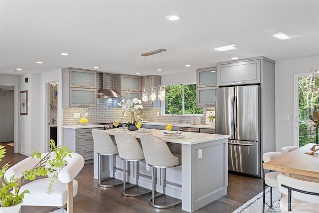 3435 103rd Pl NE, Bellevue, WA 98004 - kitchen with freestanding refrigerator, wall chimney range hood, gray cabinetry, a center island, and recessed lighting