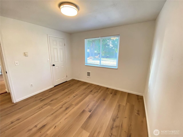 1114 Rhoton Ct NW, Yelm, WA 98597 - spare room featuring wood finished floors and baseboards