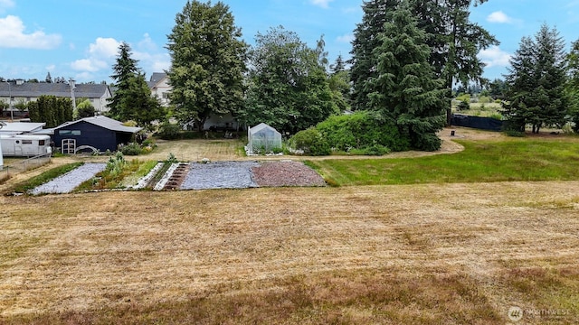 9139 Burnett Rd SE, Yelm, WA 98597 - view of yard featuring a greenhouse and an outdoor structure