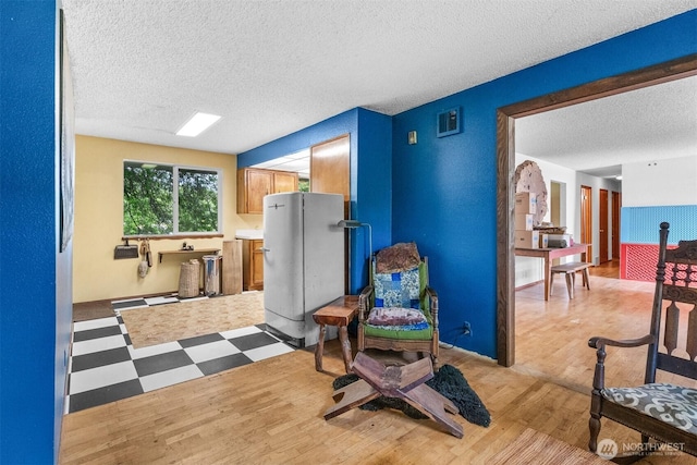 9139 Burnett Rd SE, Yelm, WA 98597 - living area with a textured ceiling and light wood-type flooring