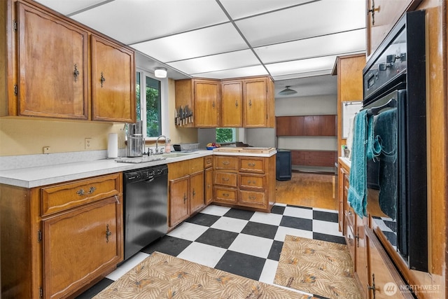 9139 Burnett Rd SE, Yelm, WA 98597 - kitchen featuring black appliances, tile patterned floors, brown cabinetry, and light countertops