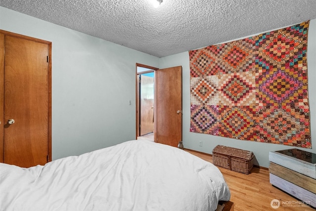 9139 Burnett Rd SE, Yelm, WA 98597 - bedroom featuring a textured ceiling and light wood-style floors