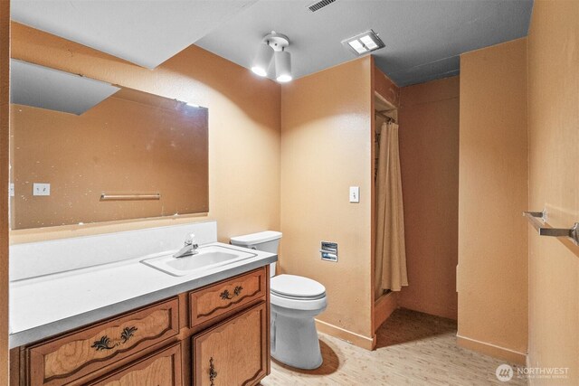 9139 Burnett Rd SE, Yelm, WA 98597 - full bath featuring vanity, wood finished floors, and a shower with curtain