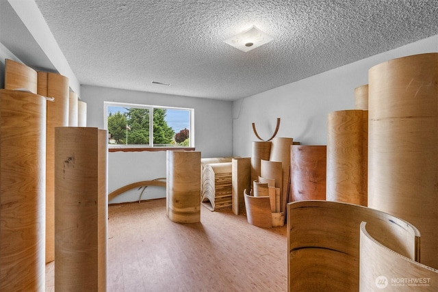 9139 Burnett Rd SE, Yelm, WA 98597 - bedroom featuring a textured ceiling and wood finished floors