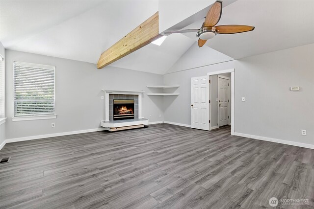 4426 82nd Avenue Ct W, University Place, WA 98466 - unfurnished living room featuring a ceiling fan, a tile fireplace, baseboards, wood finished floors, and beamed ceiling