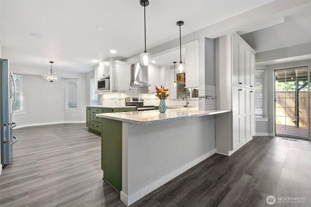 4426 82nd Avenue Ct W, University Place, WA 98466 - kitchen with wall chimney range hood, stainless steel appliances, dark wood finished floors, green cabinetry, and white cabinets