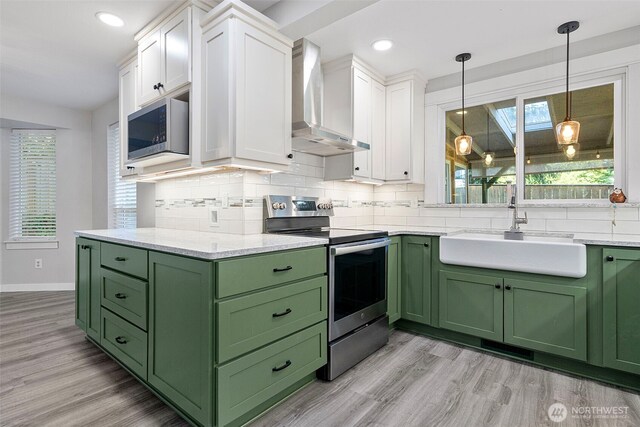 4426 82nd Avenue Ct W, University Place, WA 98466 - kitchen with green cabinets, wall chimney range hood, stainless steel appliances, a sink, and white cabinets