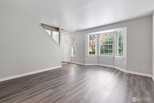 4426 82nd Avenue Ct W, University Place, WA 98466 - unfurnished living room featuring dark wood-style floors and baseboards