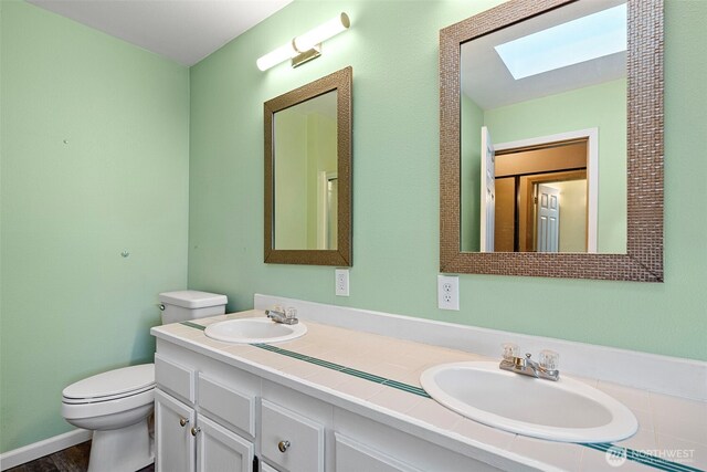 4426 82nd Avenue Ct W, University Place, WA 98466 - bathroom with a skylight, toilet, and double vanity