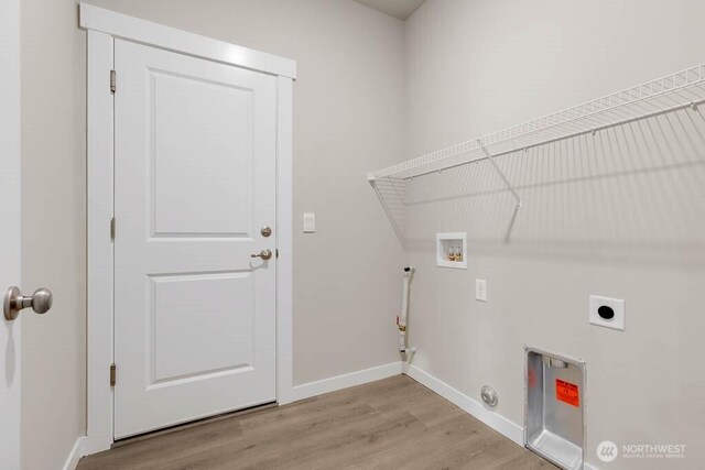 7402 281st Pl NW Unit 75, Stanwood, WA 98292 - laundry room featuring gas dryer hookup, washer hookup, electric dryer hookup, light wood-style flooring, and baseboards
