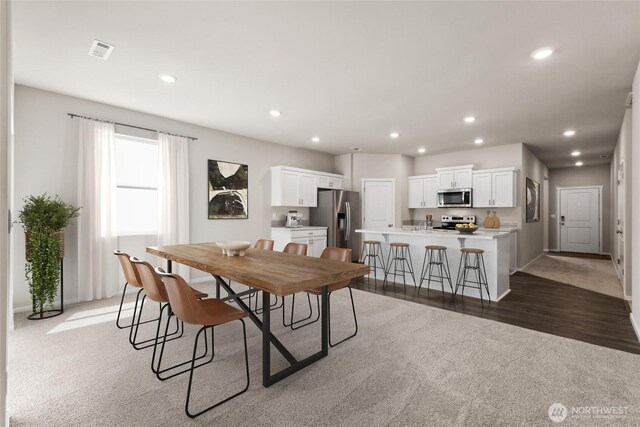 7402 281st Pl NW Unit 75, Stanwood, WA 98292 - dining area featuring recessed lighting, light colored carpet, and light wood-type flooring