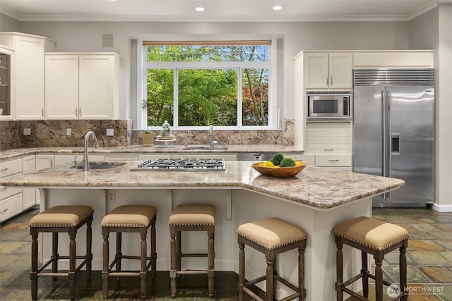 6819 SE 32nd St, Mercer Island, WA 98040 - kitchen featuring built in appliances, a sink, stone tile flooring, ornamental molding, and recessed lighting