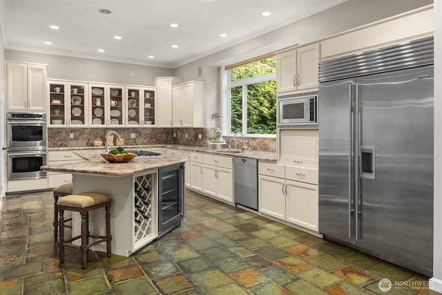 6819 SE 32nd St, Mercer Island, WA 98040 - kitchen featuring built in appliances, decorative backsplash, ornamental molding, glass insert cabinets, and white cabinets