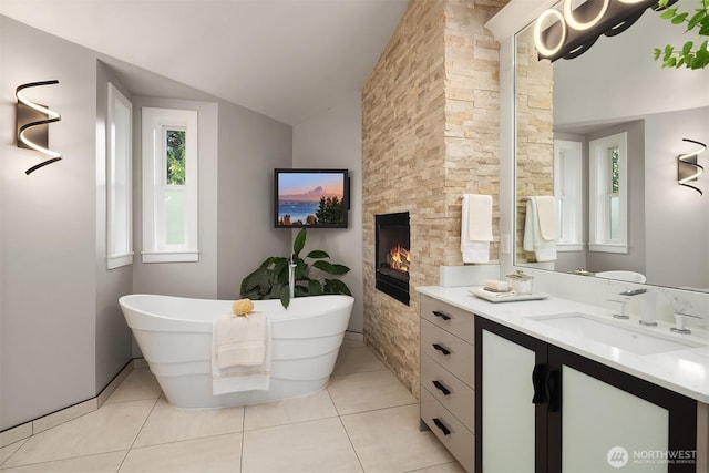 6819 SE 32nd St, Mercer Island, WA 98040 - full bathroom with vanity, a freestanding tub, a fireplace, lofted ceiling, and tile patterned floors