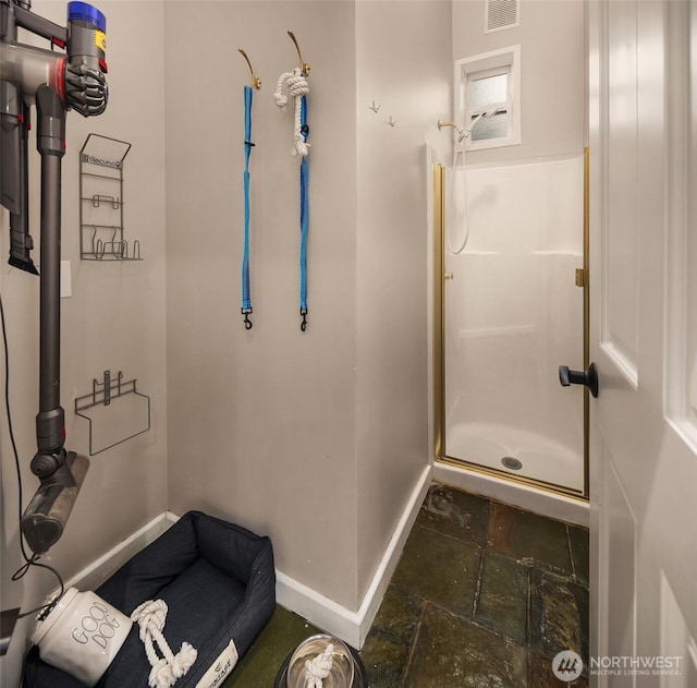 6819 SE 32nd St, Mercer Island, WA 98040 - bathroom with baseboards, stone tile floors, and a stall shower
